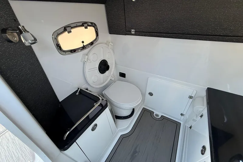 Slide: The Image of Interior of 2026 Monterey Elite 30 OB with toilet and window. - 21