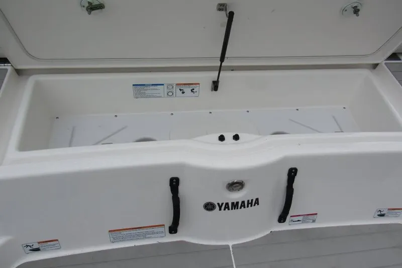 Slide: The Image of Open storage compartment of 2025 Yamaha AR250 boat, showcasing interior space. - 10