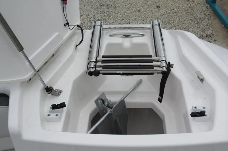 Slide: The Image of 2025 Yamaha Boats AR250 anchor storage compartment with ladder, showcasing marine design features. - 11