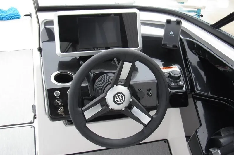 Slide: The Image of 2025 Yamaha Boats AR250 dashboard with steering wheel and control panel. - 14