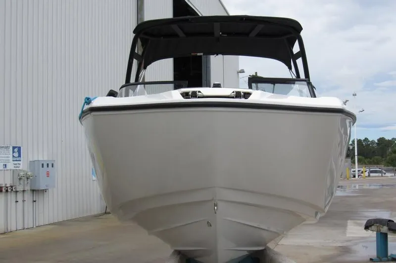 Slide: The Image of 2025 Yamaha Boats AR250 in a marina, showcasing sleek design and modern features. - 3