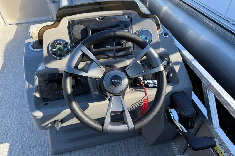 Slide: The Image of Steering console of 2026 Avalon Venture Quad Lounger pontoon boat with modern controls. - 3