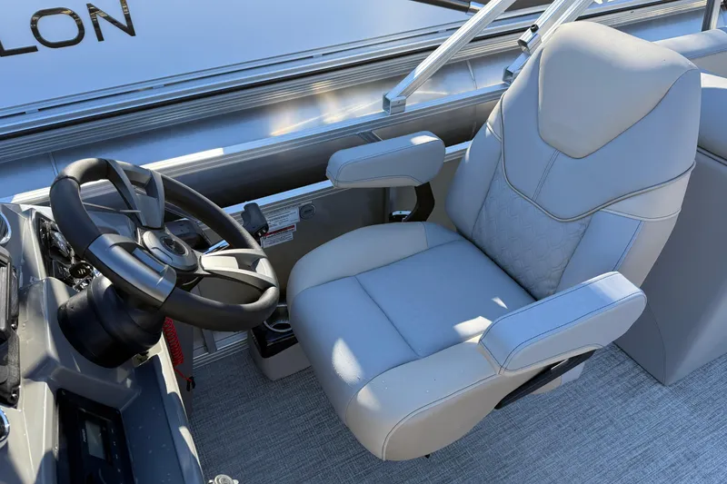 Slide: The Image of Luxurious captain's chair and steering wheel in 2026 Avalon Venture Quad Lounger boat. - 4