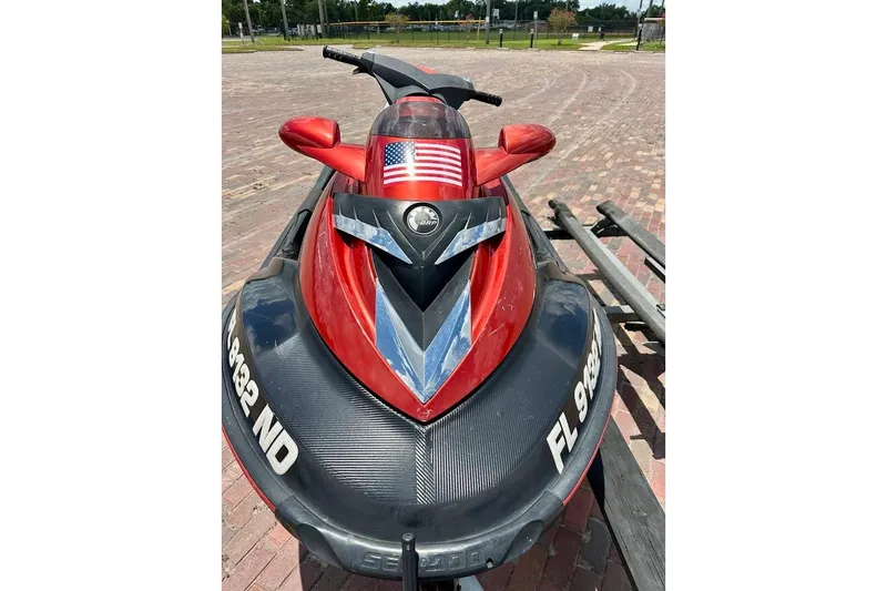 Slide: The Image of 2006 Sea-Doo RXT jet ski with American flag decal on brick pavement. - 5