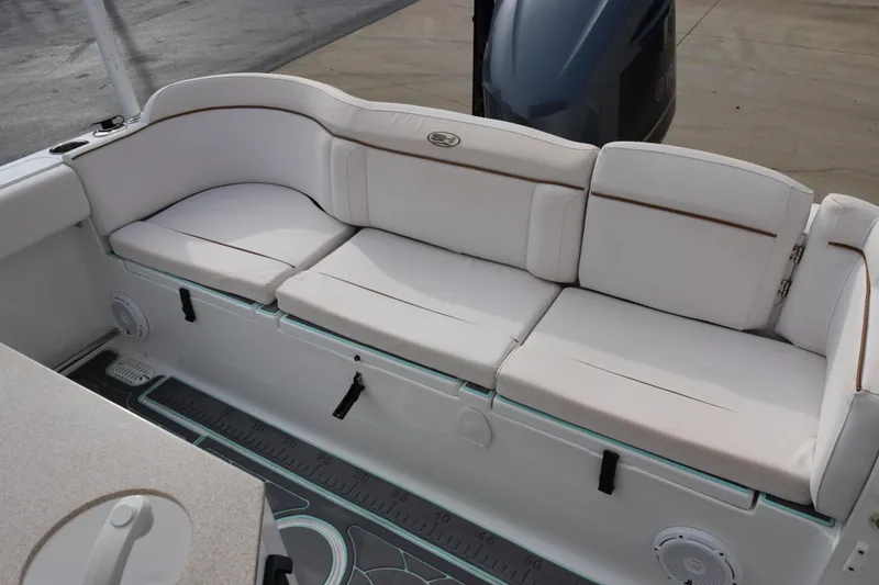 Slide: The Image of Luxurious seating on 2021 Sea Hunt Ultra 255 SE boat, featuring white cushioned seats. - 10