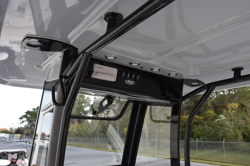 Slide: The Image of 2021 Sea Hunt Ultra 255 SE boat console with Garmin electronics and sleek black frame. - 12