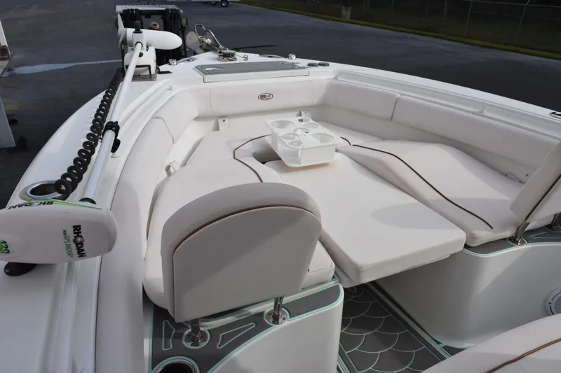 Slide: The Image of 2021 Sea Hunt Ultra 255 SE boat interior with white seating and cup holders. - 15