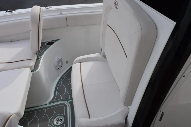 Slide: The Image of 2021 Sea Hunt Ultra 255 SE boat interior with white seating and stylish flooring. - 16