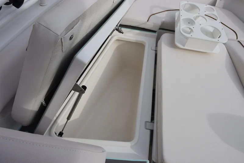 Slide: The Image of 2021 Sea Hunt Ultra 255 SE boat storage compartment with cup holders. - 20