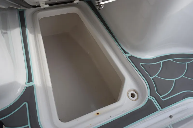 Slide: The Image of Storage compartment on 2021 Sea Hunt Ultra 255 SE boat with stylish flooring design. - 21