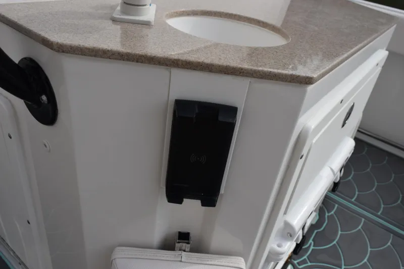 Slide: The Image of 2021 Sea Hunt Ultra 255 SE boat interior with sink and storage area. - 25