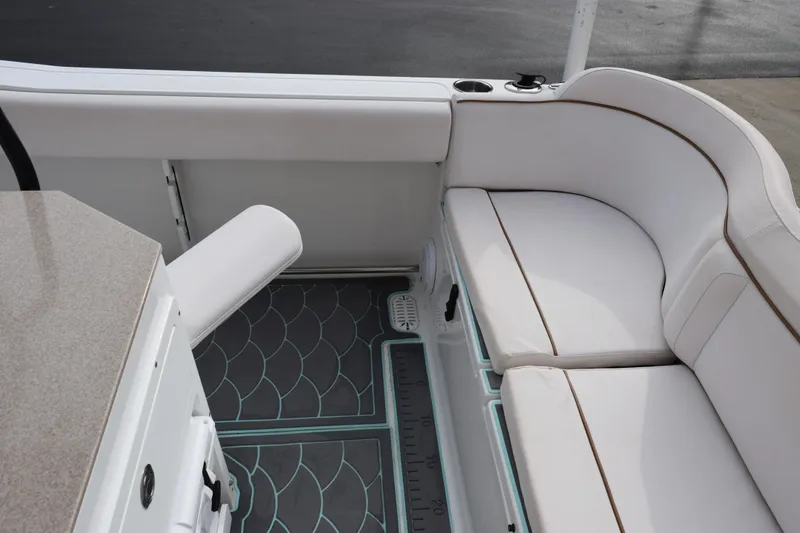 Slide: The Image of 2021 Sea Hunt Ultra 255 SE boat interior with white cushioned seating and patterned flooring. - 26