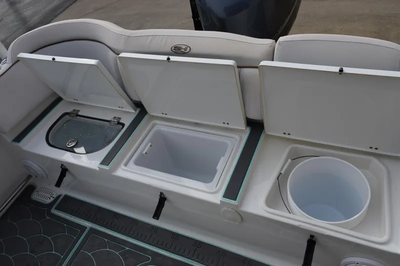Slide: The Image of 2021 Sea Hunt Ultra 255 SE boat storage compartments with open lids. - 29