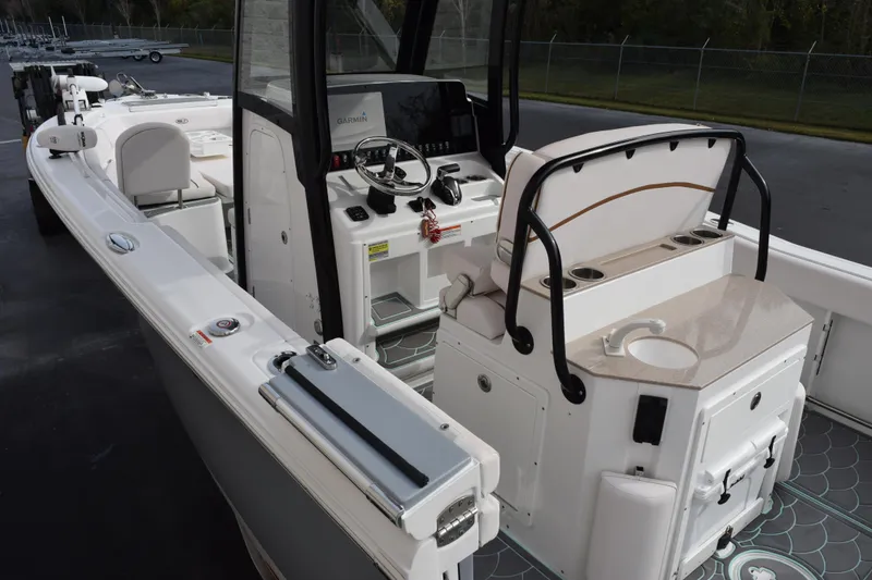 Slide: The Image of 2021 Sea Hunt Ultra 255 SE boat interior with helm and seating area. - 7