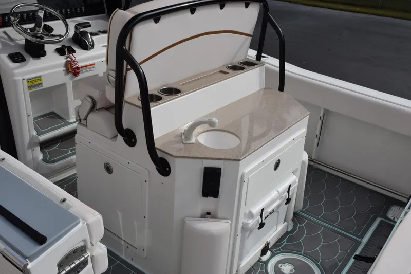 Slide: The Image of Interior of 2021 Sea Hunt Ultra 255 SE boat with helm and sink area. - 8