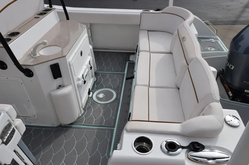 Slide: The Image of 2021 Sea Hunt Ultra 255 SE boat interior with seating and sink area. - 9