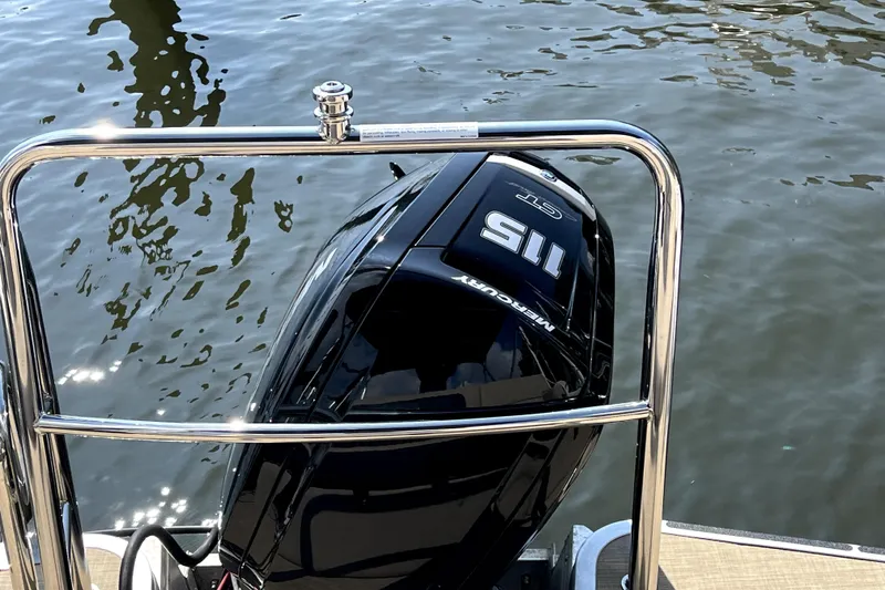 Slide: The Image of Outboard motor on a Harris HCX23 boat, 2025 model, near water. - 9