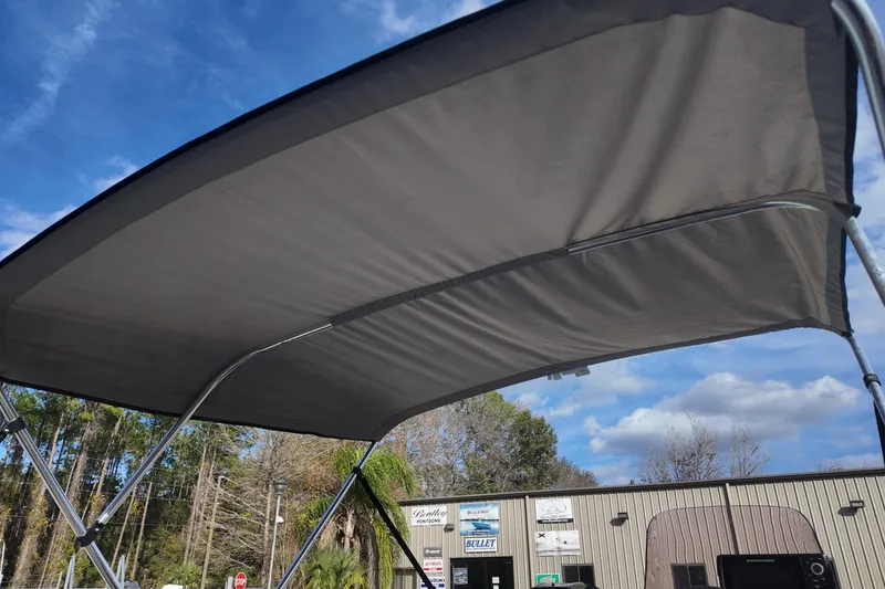 Slide: The Image of 2020 Bass Tracker Classic XL boat with canopy under blue sky. - 13