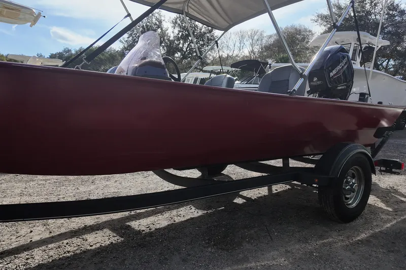 Slide: The Image of 2020 Bass Tracker Classic XL boat on trailer, red hull, outdoor setting. - 4
