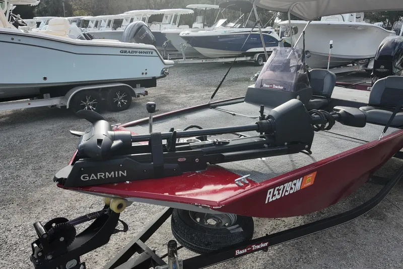 Slide: The Image of 2020 Bass Tracker Classic XL boat with Garmin equipment, parked among other boats. - 6