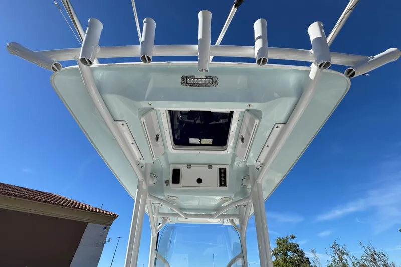 Slide: The Image of 2021 Sea Fox 268 Commander boat top view with rod holders against blue sky. - 28