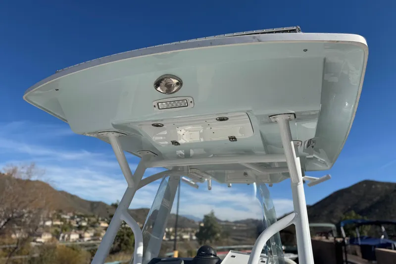 Slide: The Image of 2021 Sea Fox 268 Commander boat's T-top structure against a clear blue sky. - 30