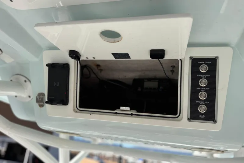 Slide: The Image of 2021 Sea Fox 268 Commander control panel with open compartment and light switches. - 34