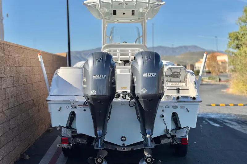Slide: The Image of 2021 Sea Fox 268 Commander boat with dual Yamaha 200 engines, parked outdoors. - 4