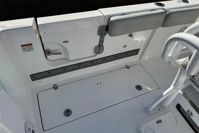 Slide: The Image of 2021 Sea Fox 268 Commander boat interior with storage compartments and measurement scale. - 40