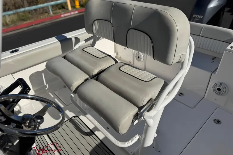 Slide: The Image of 2021 Sea Fox 268 Commander boat seat and steering wheel, featuring white cushioned seating. - 52