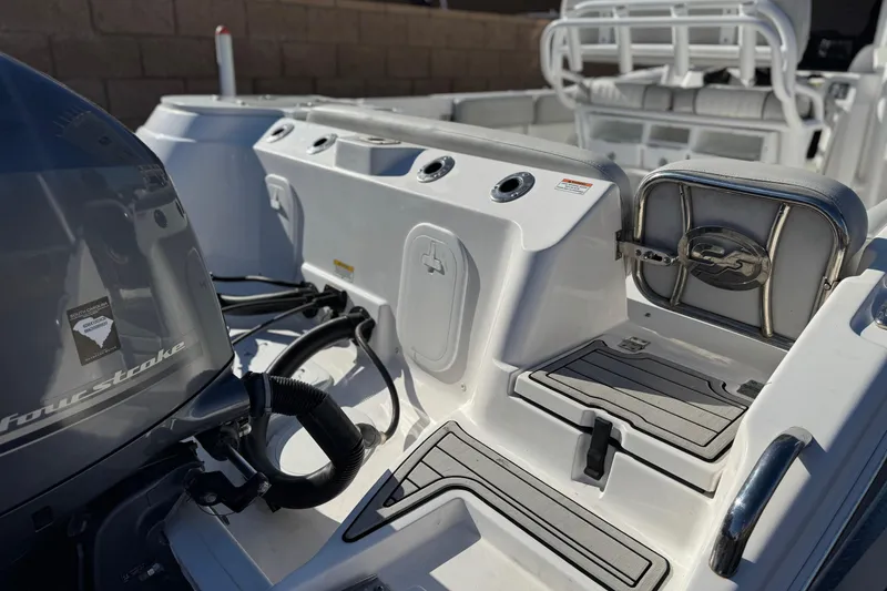 Slide: The Image of 2021 Sea Fox 268 Commander boat interior with motor and seating area. - 8