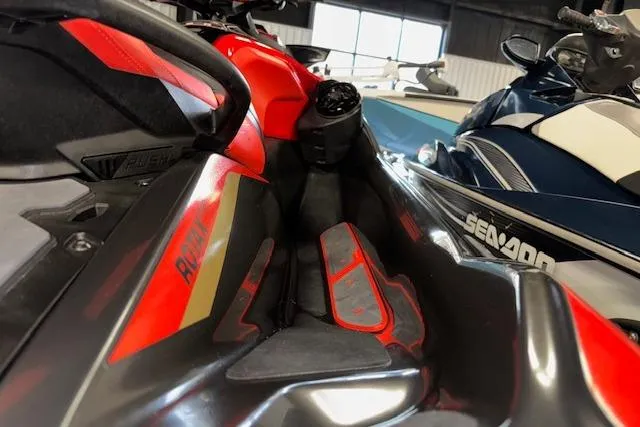 Slide: The Image of 2020 Sea-Doo RXT-X 300 jet ski, red and black, close-up view in showroom. - 10
