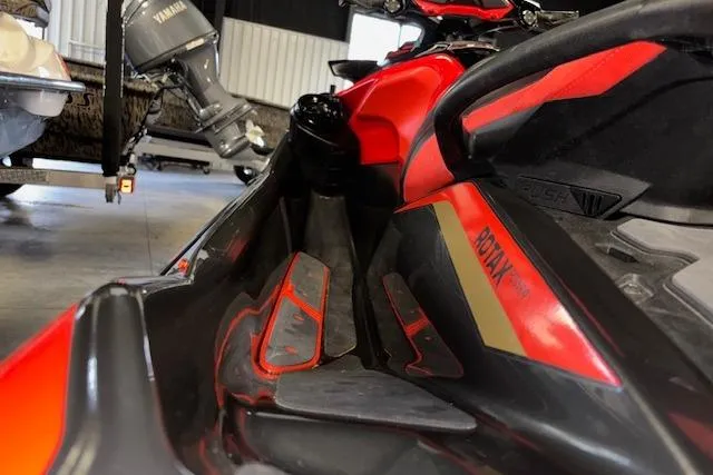 Slide: The Image of 2020 Sea-Doo RXT-X 300 jet ski, red and black, in a garage setting. - 11