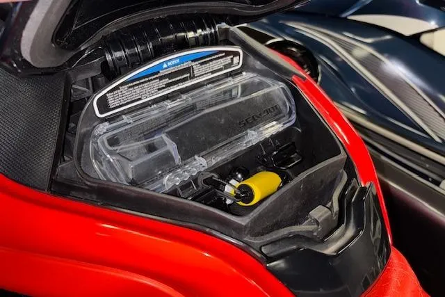 Slide: The Image of 2020 Sea-Doo RXT-X 300 storage compartment with safety equipment and manual. - 15