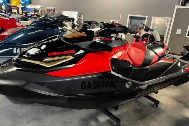 Slide: The Image of 2020 Sea-Doo RXT-X 300 jet ski in showroom, black and red design. - 3
