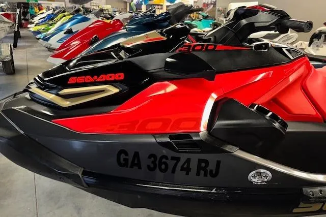 Slide: The Image of 2020 Sea-Doo RXT-X 300 jet ski in vibrant red and black, side view. - 4