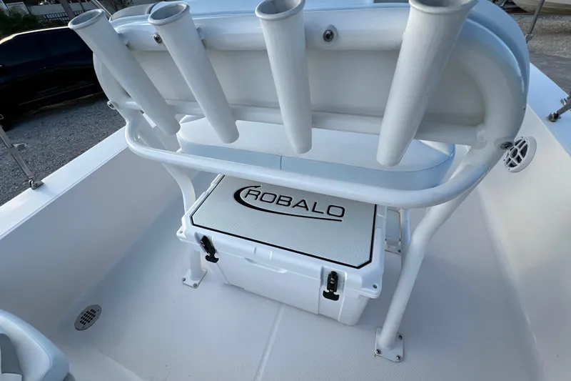 Slide: The Image of 2024 Robalo 206 Cayman boat interior with rod holders and branded cooler. - 12