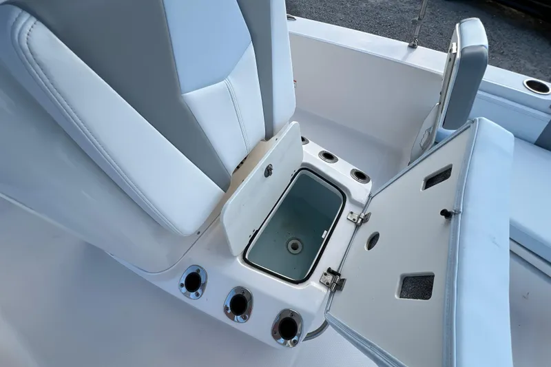 Slide: The Image of 2024 Robalo 206 Cayman boat interior with open storage compartment and seating. - 15