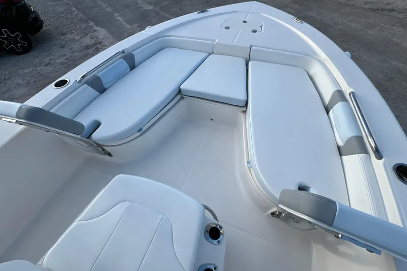 Slide: The Image of 2024 Robalo 206 Cayman boat interior with cushioned seating and cup holders. - 18