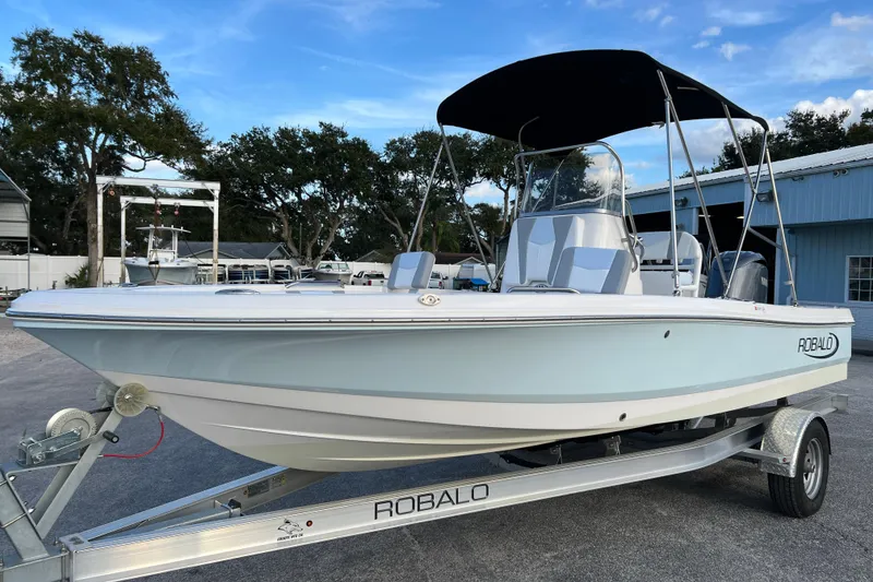 Slide: The Image of 2024 Robalo 206 Cayman boat on trailer, featuring sleek design and canopy. - 4