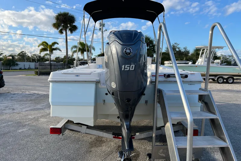 Slide: The Image of 2024 Robalo 206 Cayman boat with Yamaha 150 engine, parked outdoors. - 7
