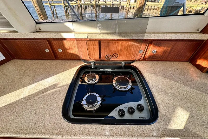 Slide: The Image of Three burner stove and plenty of counter space and storage behind stove - 10