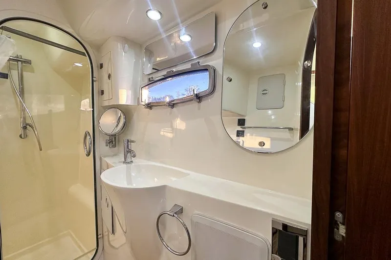 Slide: The Image of Glass door shower, mirrors, and built in storage inside the luxurious head - 18