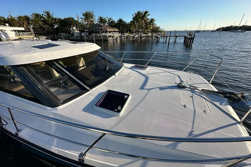Slide: The Image of The bow of the 420 features an integrated anchor, storage lockers, opening master berth windows, and wraparound safety rails - 26