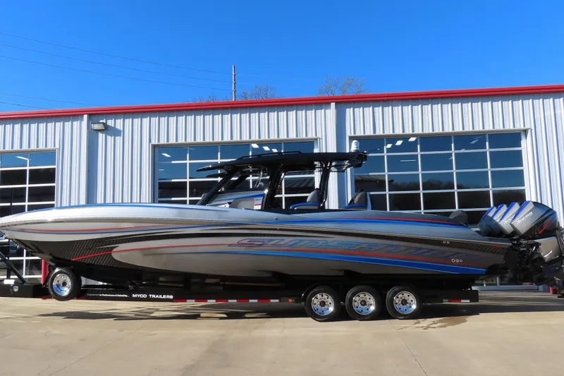 The Image of 2021 Sunsation Powerboats 40CCX on trailer, sleek design, vibrant colors, parked outside a garage. - 1