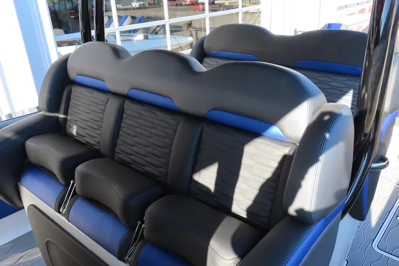 Slide: The Image of 2021 Sunsation Powerboats 40CCX interior seating with black and blue upholstery. - 11