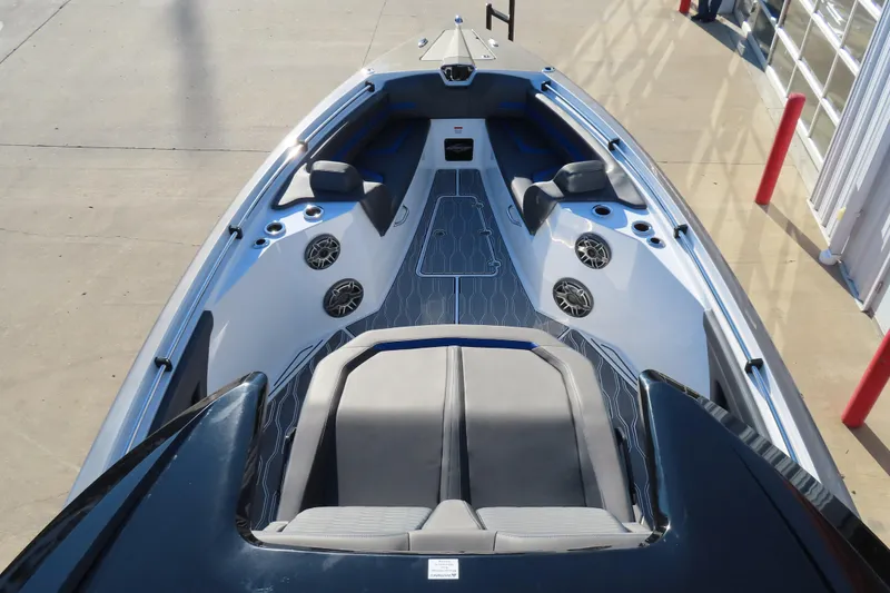 Slide: The Image of 2021 Sunsation Powerboats 40CCX interior with seating and speakers, docked on concrete. - 17