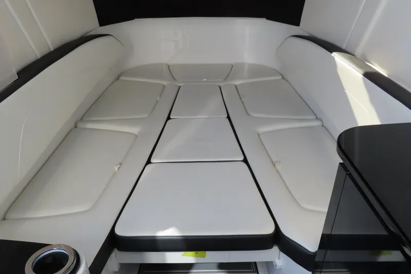 Slide: The Image of 2021 Sunsation Powerboats 40CCX cabin interior with white cushioned seating. - 7