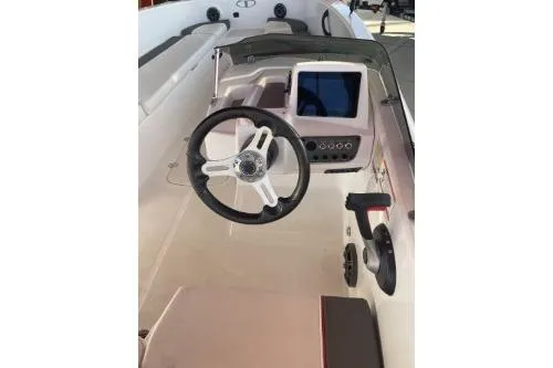 Slide: The Image of 2024 Tahoe T18 boat interior with steering wheel and control panel. - 4