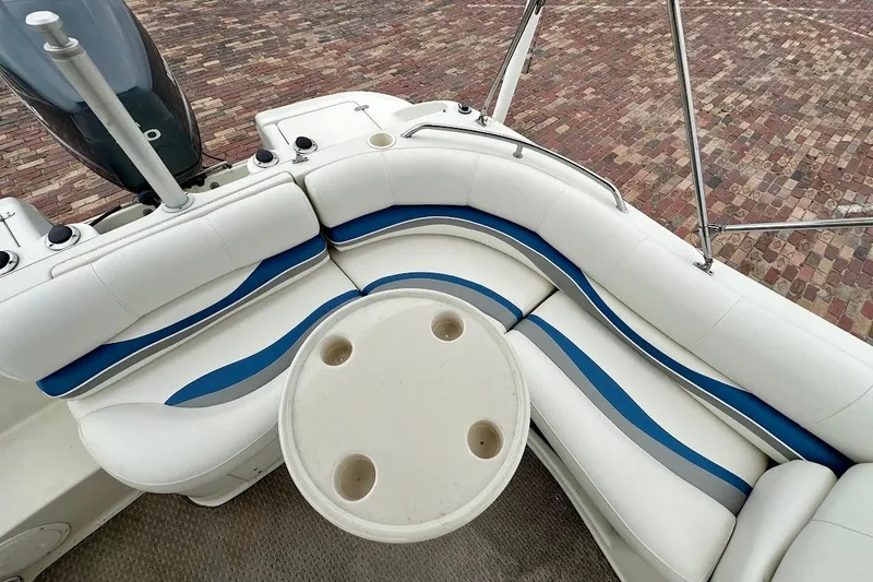 Slide: The Image of 2004 Bennington RL 210 boat interior with white and blue seating and round table. - 20